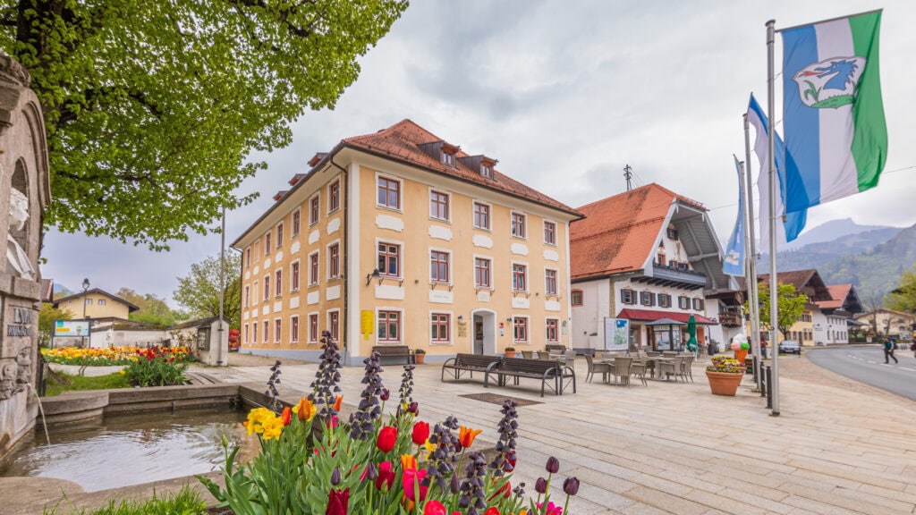 Blick auf den Kirchplatz mit der Tourist Info Grassau, hier finden die AVACOMM Glasfasersprechstunden statt.